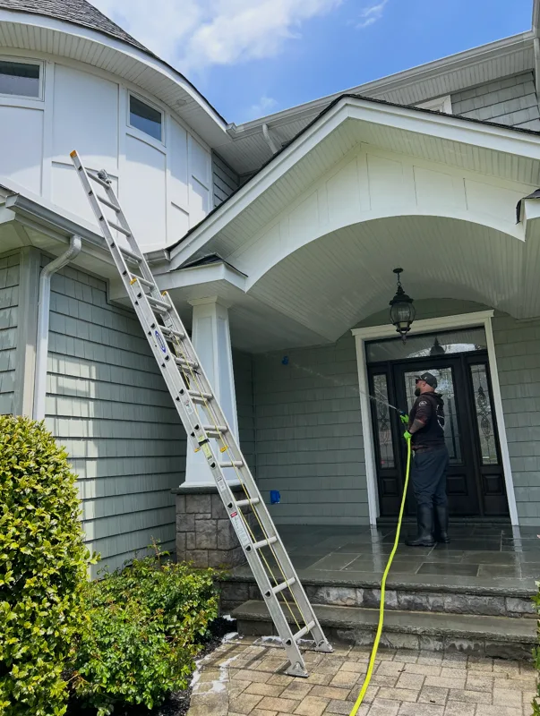 Jas Power Washing team member in action on a Long Island residential property